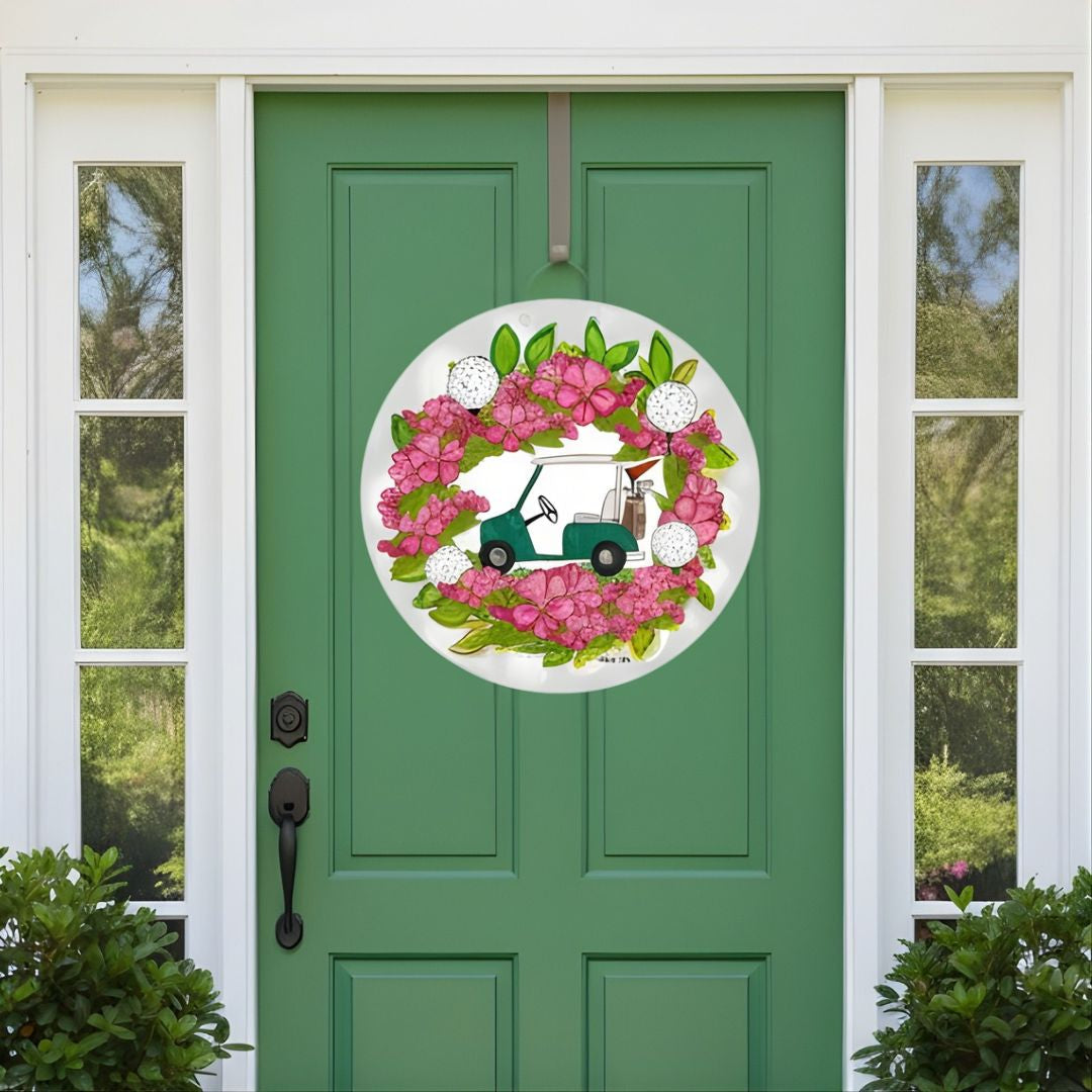 Decorative door hanger featuring an azalea wreath with flower a green golf cart - hanging on a green door.
