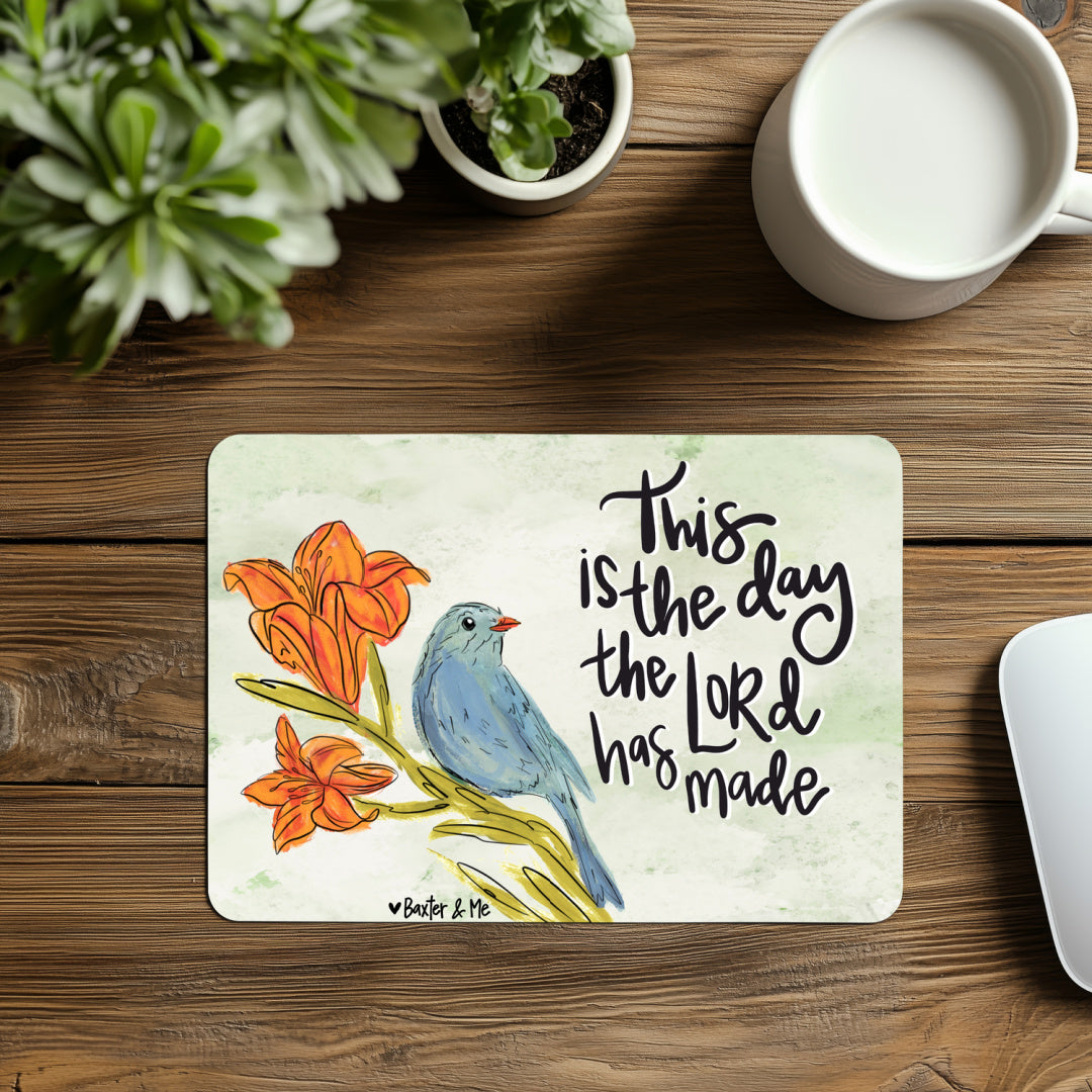 Decorative placemat with a bird and flower design on a wooden table with a cup of coffee.