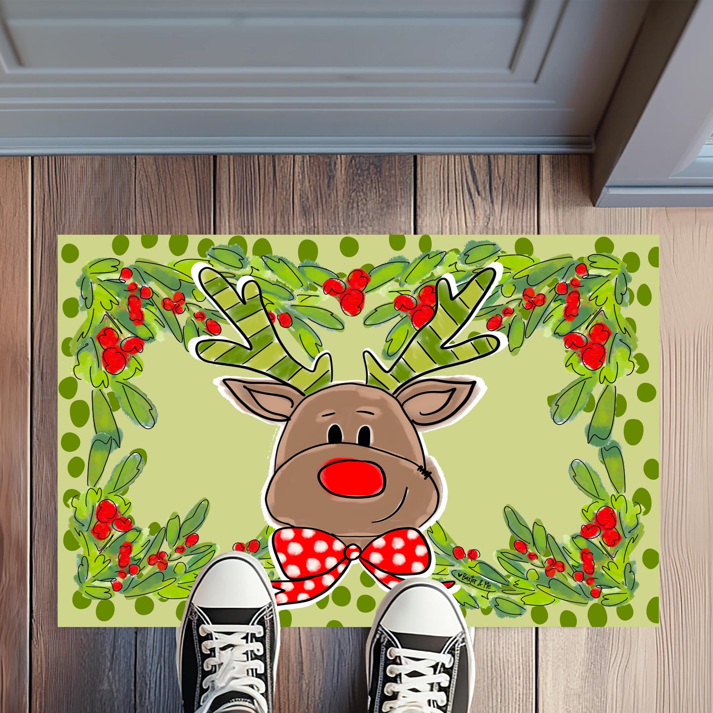 Decorative doormat with a reindeer design on a wooden floor.