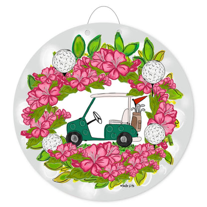 Decorative door hanger with a green golf cart, pink azalea flowers, and golf balls on a white background