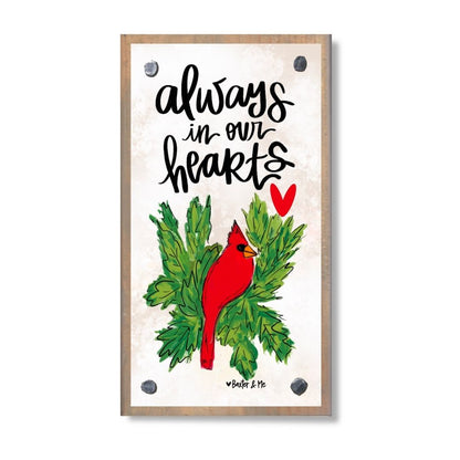 Card with red cardinal bird and green leaves, featuring the text 'always in our hearts'.