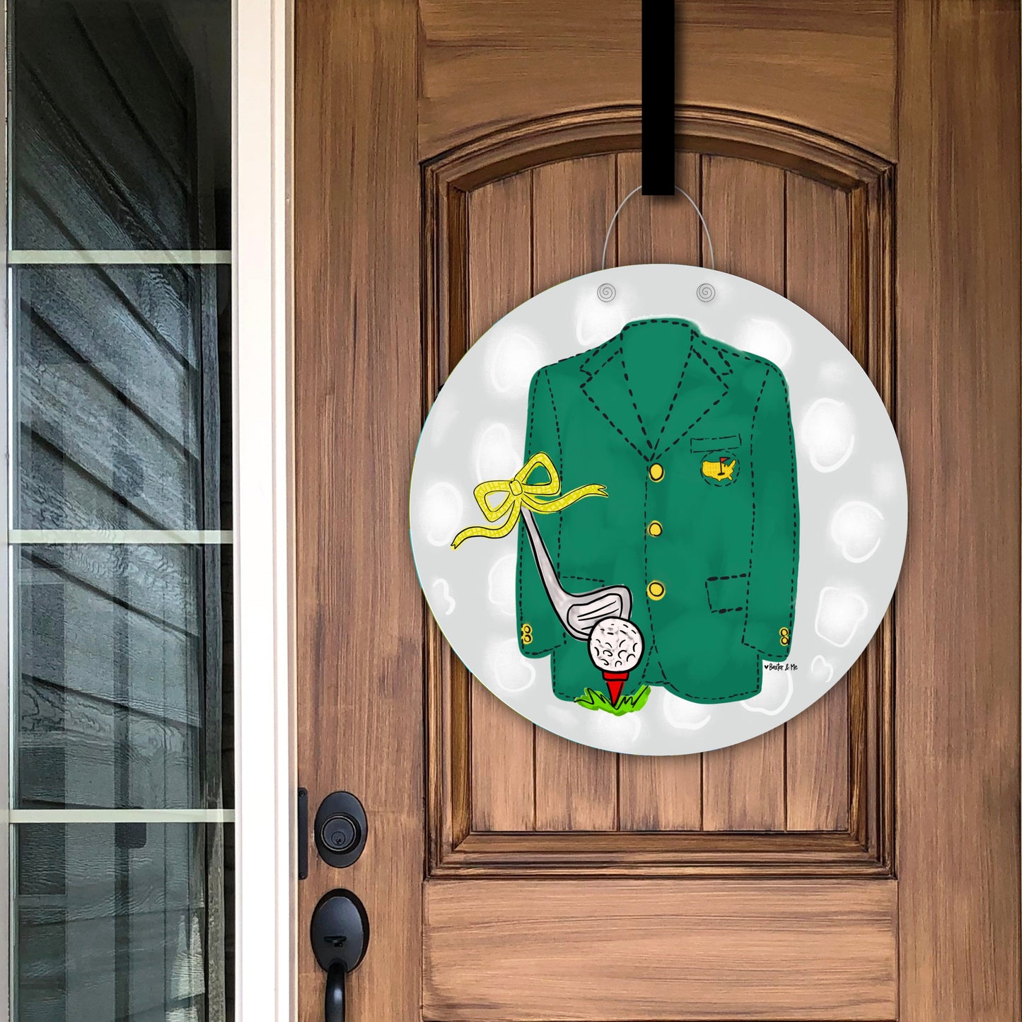 Decorative door hanger with a green jacket, golf club, and ball hanging on a wooden door.