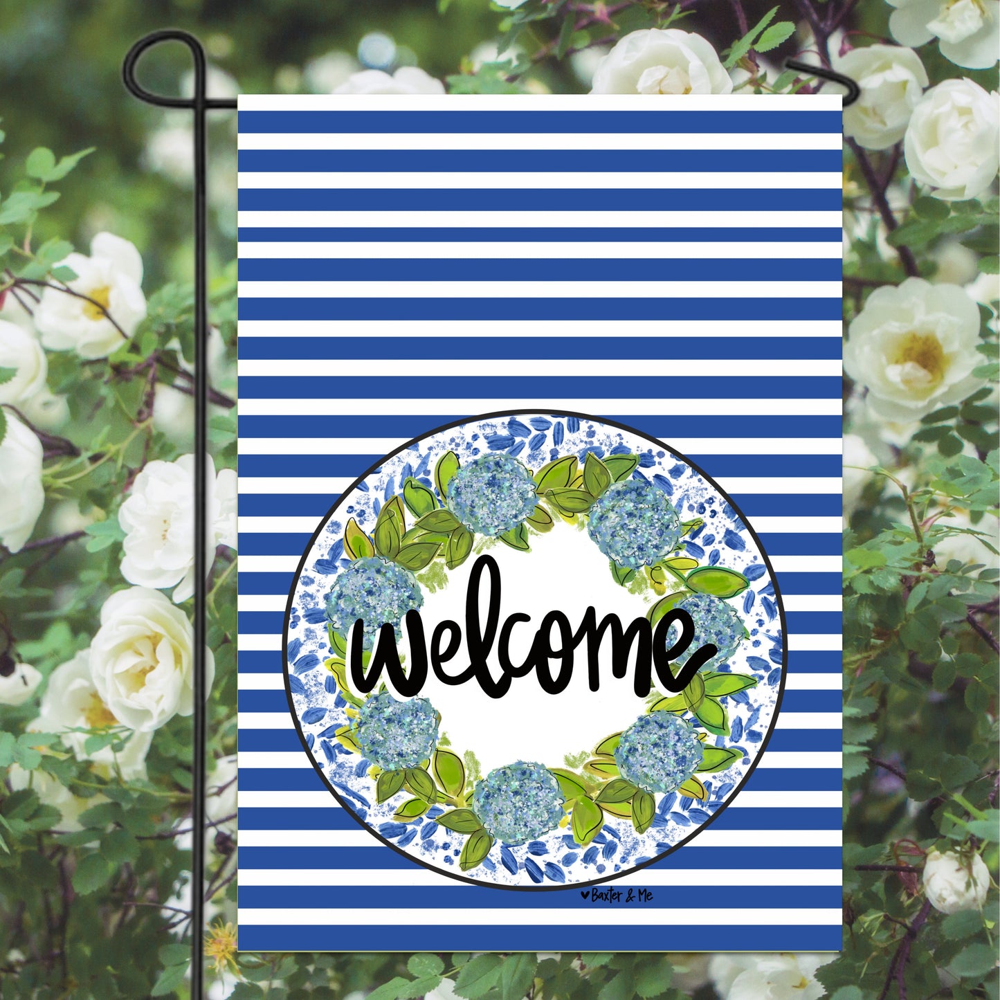 Garden flag with blue and white stripes and floral wreath design, featuring the word 'welcome'.