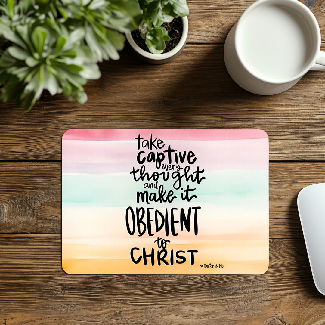 Decorative mat with motivational quote on a wooden surface with a plant and mug.