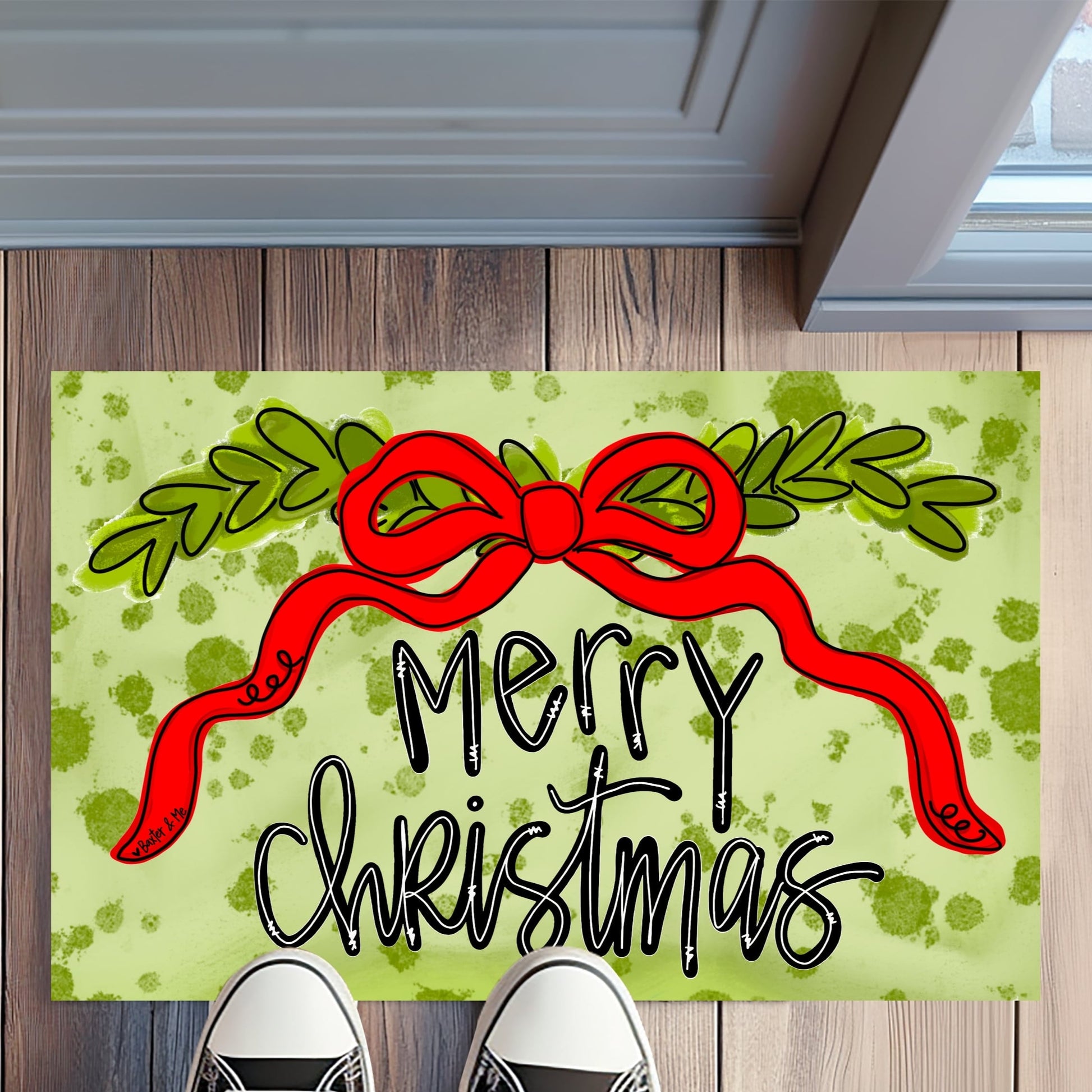 Christmas doormat with a red bow and 'Merry Christmas' text on a wooden floor.