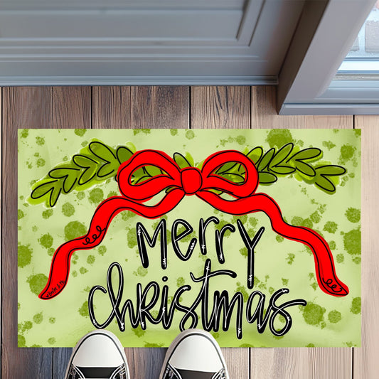 Christmas doormat with a red bow and 'Merry Christmas' text on a wooden floor.