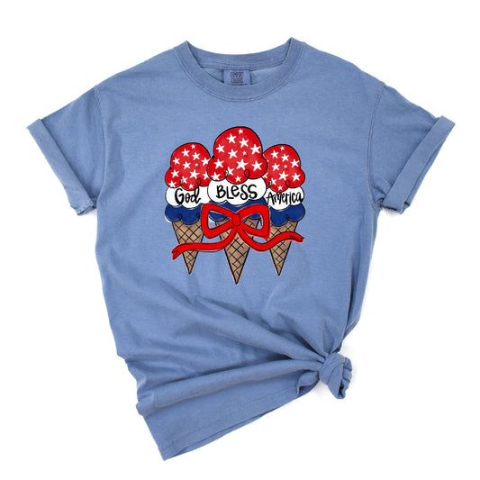 Blue t-shirt with ice cream cone graphic and 'God Bless America' text on a white background
