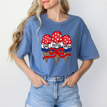 Person wearing a blue t-shirt with ice cream cone graphic and 'God Bless America' text.