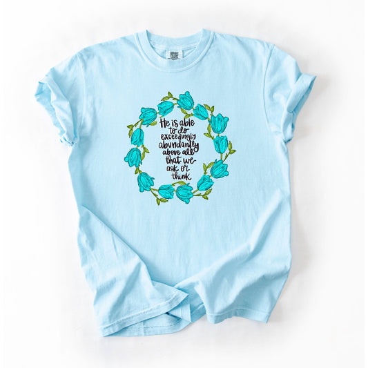 Light blue t-shirt with floral design and text on a white background